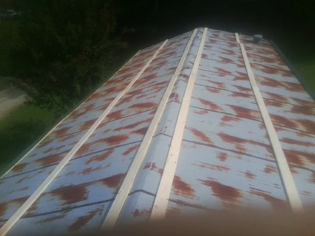 Rusted metal roof panels with new wood purlins before replacement — Storm Damage Roof Repair in Cecil by Roofing Brothers